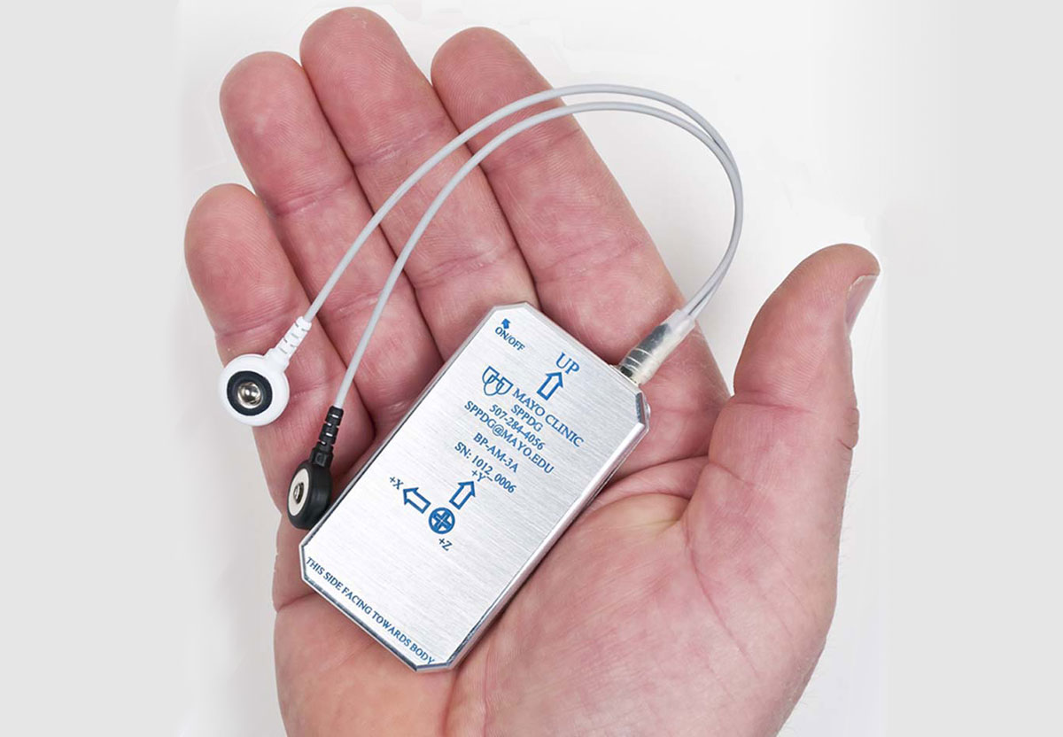 Another view of the body-worn physiological monitoring unit, illustrating the two ECG electrode wires